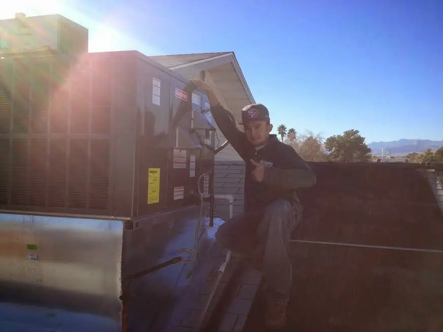 HVAC technician performing HVAC Inspection on a rooftop unit in Myrtle Beach